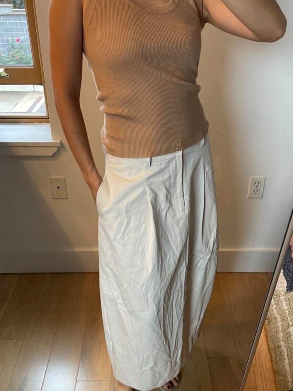 Tan ribbed knit tank top with a scoop neck and sleeveless design